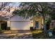 Charming single-story home featuring a well-manicured lawn, brick facade, and a welcoming blue front door at 1493 Hyde Park Dr, Winter Park, FL 32792