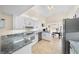 Well-lit kitchen featuring white cabinets, modern appliances, and an open layout at 1493 Hyde Park Dr, Winter Park, FL 32792