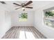 Clean bedroom featuring wood-look floors, neutral paint, and a ceiling fan at 15 Palmira Rd, Debary, FL 32713