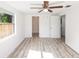 Bright bedroom with a ceiling fan, wood-look flooring and a window offering natural light at 15 Palmira Rd, Debary, FL 32713