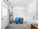 Functional utility room featuring water heater, water softener, and ample shelving for efficient storage solutions at 15 Palmira Rd, Debary, FL 32713