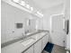 Bathroom featuring double sink, ample counter space, and large mirror, perfect for busy mornings at 15036 Willow Arbor Cir, Orlando, FL 32824