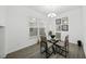 Dining room features hardwood floors, contemporary art, and a modern chandelier at 15036 Willow Arbor Cir, Orlando, FL 32824