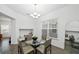 Bright dining area features hardwood floors, a chandelier and a glass-top table at 15036 Willow Arbor Cir, Orlando, FL 32824