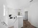 Bright hallway featuring a staircase and neutral colored walls and carpet at 15036 Willow Arbor Cir, Orlando, FL 32824