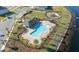 Aerial view of community pool, lounge area and playground by a lake at 15036 Willow Arbor Cir, Orlando, FL 32824