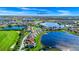 Overhead view of a beautiful lakefront neighborhood and a spacious home with a red roof at 15469 Shorebird Ln, Winter Garden, FL 34787