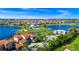 Beautiful aerial shot of a lakeside home with a pool, mature trees, and manicured landscaping at 15469 Shorebird Ln, Winter Garden, FL 34787