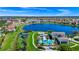 Expansive community with homes nestled along a scenic lake, with amenities including a pool and lush landscaping at 15469 Shorebird Ln, Winter Garden, FL 34787