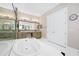 Elegant bathroom featuring a soaking tub, double vanity, and a glass-enclosed shower at 15469 Shorebird Ln, Winter Garden, FL 34787