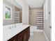 Bright bathroom featuring a dark wood vanity, white countertops, and a shower-tub combo with a decorative curtain at 15469 Shorebird Ln, Winter Garden, FL 34787