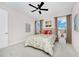 Inviting bedroom featuring a floral-patterned bed, stylish lamps, and bright windows, creating a cheerful ambiance at 15469 Shorebird Ln, Winter Garden, FL 34787