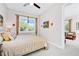 Bedroom with comfortable bed, neutral colors, and bright window, leading into another living space at 15469 Shorebird Ln, Winter Garden, FL 34787