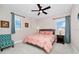 Cozy bedroom featuring a large window, ceiling fan, and warm lighting for a relaxing atmosphere at 15469 Shorebird Ln, Winter Garden, FL 34787