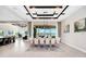 A dining room featuring a coffered ceiling, chandelier, tile floors, neutral paint, and view to the lake at 15469 Shorebird Ln, Winter Garden, FL 34787