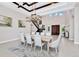 Open-concept dining room with a large dining table, elegant chandelier, and a staircase to the second floor at 15469 Shorebird Ln, Winter Garden, FL 34787