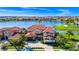 Stunning aerial view of a luxurious home with a red tile roof and lush landscaping on a waterfront lot at 15469 Shorebird Ln, Winter Garden, FL 34787