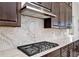 Modern kitchen with granite counters, stainless hood, and dark wood cabinets at 15469 Shorebird Ln, Winter Garden, FL 34787