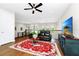 Bright upstairs living room with hardwood floors, black iron railings, and views from large picture windows at 15469 Shorebird Ln, Winter Garden, FL 34787