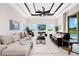 Living room features tray ceiling, large windows with backyard views, and fireplace at 15469 Shorebird Ln, Winter Garden, FL 34787