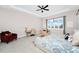 Beautifully designed main bedroom with a ceiling fan, sitting area, and stylish decor at 15469 Shorebird Ln, Winter Garden, FL 34787