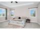 Bright main bedroom featuring a large window, ceiling fan, and a plush king-size bed at 15469 Shorebird Ln, Winter Garden, FL 34787