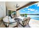 This outdoor space features a large patio, furniture, ceiling fan, and a water view at 15469 Shorebird Ln, Winter Garden, FL 34787