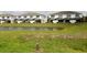 Backyard view of the screened in lanai on two-story home overlooking the pond at 17519 Blessing Dr, Clermont, FL 34714