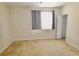 This carpeted bedroom features a window with gray curtains and white door trim at 17519 Blessing Dr, Clermont, FL 34714