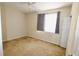 This carpeted bedroom features a window with gray curtains and white door trim at 17519 Blessing Dr, Clermont, FL 34714