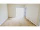 Empty room with beige carpet, sliding glass door, and neutral paint at 17519 Blessing Dr, Clermont, FL 34714