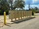 A row of community mailboxes with yellow poles on a concrete slab, ready for resident use at 17519 Blessing Dr, Clermont, FL 34714