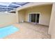 This screened in pool is surrounded by brick pavers and leads to a sliding door at 17519 Blessing Dr, Clermont, FL 34714