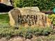 A stone community welcome sign set in a garden of flowering bushes at 17519 Blessing Dr, Clermont, FL 34714