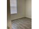 Empty room with a large window and modern wood-look tile flooring at 1958 Sawfish Dr, Kissimmee, FL 34759