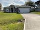 Beautiful one-story home with a well-maintained lawn and a two-car garage at 1958 Sawfish Dr, Kissimmee, FL 34759