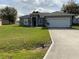 Charming single-story home with a manicured lawn and a two-car garage at 1958 Sawfish Dr, Kissimmee, FL 34759