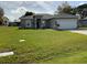 Well-maintained home with a lush green lawn and a two-car garage at 1958 Sawfish Dr, Kissimmee, FL 34759