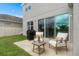 Outdoor patio with seating and grill, overlooking fenced yard with lush green grass at 2091 Brillante Dr, St Cloud, FL 34771