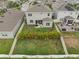 Well-maintained backyard featuring a patio area with seating, lush landscaping, and a pristine lawn surrounded by a white fence at 2091 Brillante Dr, St Cloud, FL 34771