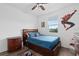 A bedroom decorated in a Spiderman theme, with a bed, dark wood furniture, and a ceiling fan at 2091 Brillante Dr, St Cloud, FL 34771