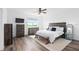 Comfortable bedroom with a queen bed, a ceiling fan, and an array of furniture including dressers and a bench at 2091 Brillante Dr, St Cloud, FL 34771