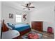 Bedroom decorated with a Spiderman theme, featuring a dark wood dresser, bed, and ceiling fan at 2091 Brillante Dr, St Cloud, FL 34771