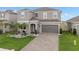 Two-story home featuring a two-car garage, tidy landscaping, and a welcoming front entrance at 2091 Brillante Dr, St Cloud, FL 34771