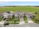 Charming home exterior with a well-manicured lawn, landscaped front yard, paved driveway, and a two-car garage at 2091 Brillante Dr, St Cloud, FL 34771