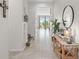 Inviting foyer with neutral tile flooring, decorative accents, and natural light streaming through the rear windows at 2091 Brillante Dr, St Cloud, FL 34771