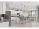 Open concept kitchen with white cabinets, granite counters, stainless appliances, and an eat-in island at 2091 Brillante Dr, St Cloud, FL 34771