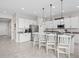 Bright kitchen with white cabinetry, granite countertops, stainless appliances and breakfast bar at 2091 Brillante Dr, St Cloud, FL 34771
