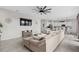 Open concept living room with a large comfortable couch, ceiling fan and a view into the kitchen at 2091 Brillante Dr, St Cloud, FL 34771