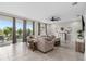 Spacious living room with a ceiling fan, sliding glass doors and a comfortable couch with decorative pillows at 2091 Brillante Dr, St Cloud, FL 34771